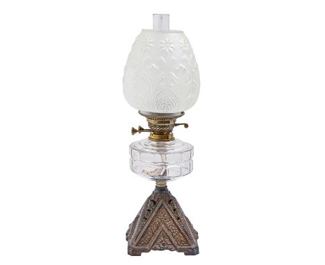 A Victorian oil lamp, with pyramidal cast iron foot and moulded glass fount, brass burner, 54cm h including a frosted glass s