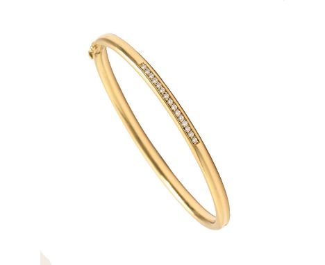 A diamond bangle, in gold, 60mm (internal), control marks and 750, 22.3g  Good condition