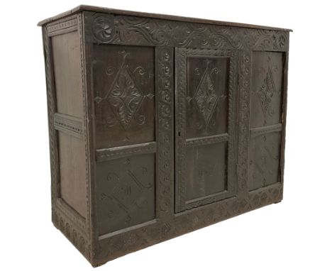 17th century and later carved oak cupboard, rectangular top with moulded edge over a frieze carved with s-scrolls and palmett