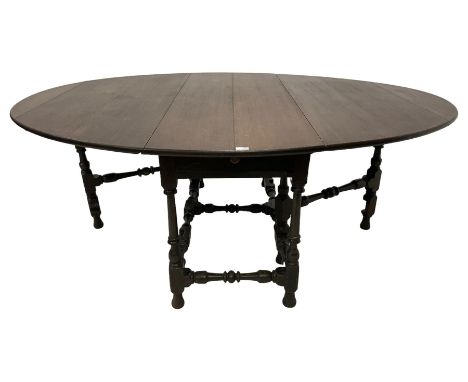 18th century oak dining table, oval-drop leaf top over two end drawers, gate-leg action base, on turned supports united by tu
