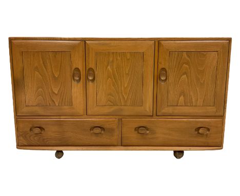 Ercol - mid-20th century elm 'Windsor' sideboard, fitted with three cupboards over two drawers, on castorsDimensions: Height: