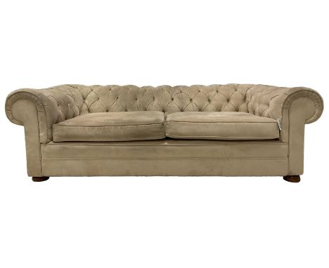 Large two-seat Chesterfield sofa, upholstered in cream suede, on front turned compressed bun feetDimensions: Height:&nbsp;65c