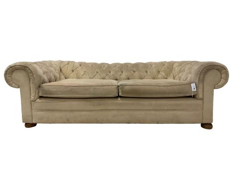 Large two-seat Chesterfield sofa, upholstered in cream suede, on front turned compressed bun feetDimensions: Height:&nbsp;65c