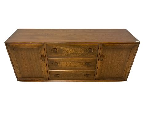 Ercol - mid-20th century elm 'Windsor' sideboard, fitted with three drawers flanked by two cupboards, on castorsDimensions: H