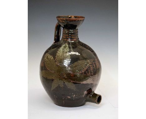 Abuja Pottery (attr.) stoneware flagon, ovoid with everted neck, strap handle and threaded stopper, resist decorated with lea