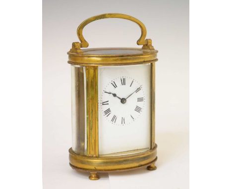 French gilt metal oval carriage timepiece, having a Roman enamel dial with blued steel spade hands, oval bevelled glazing to 
