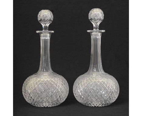 Pair of cut glass decanters, probably late Victorian, of globe and shaft form with globe stoppers, 28cm high