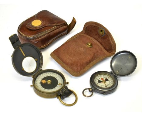 British field compass within brown leather case, together with gun metal cased compass with leather case partially stamped 'C