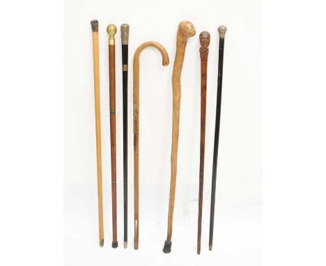 Quantity of walking sticks and canes to include a 20th century 'tipple stick', silver topped cane, etc, 91cm high approx and 