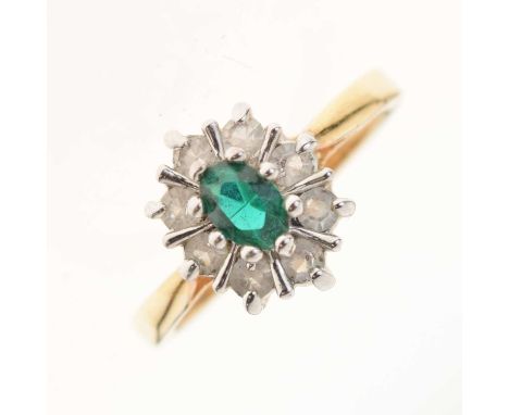 Dress ring set green oval cut centre stone within a border of white stones, the shank stamped '14ct', size R, 3.6g gross appr