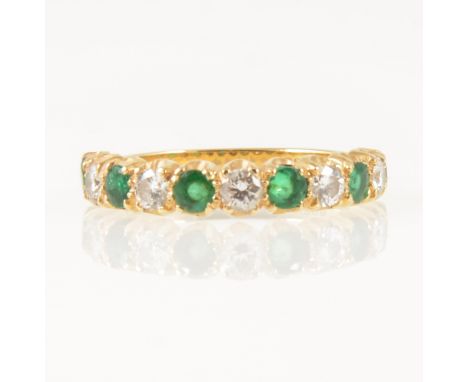 An emerald and diamond half eternity ring, five emeralds and five brilliant cut diamonds claw set in an 18 carat yellow gold 