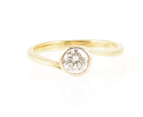 A diamond solitaire ring, the brilliant cut stone collet set in an 18 carat all yellow gold single stone mount with crossover