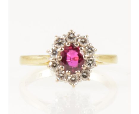 A ruby and diamond oval cluster ring, the oval mixed cut ruby claw set and surrounded by ten brilliant cut diamonds in an 18 