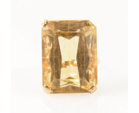 A citrine dress ring, the rectangular step cut stone 24mm x 17.5mm, set with three claws (one missing) in a 9 carat yellow go