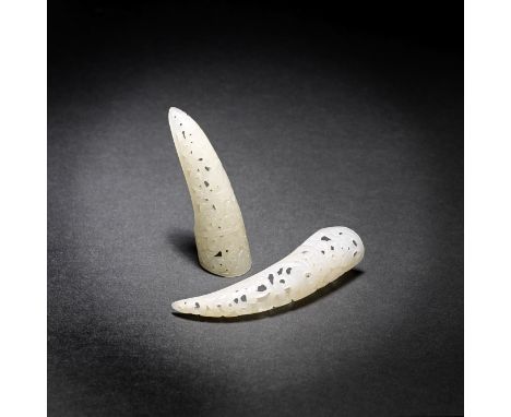 Two white jade nail guardsLate Qing DynastyEach of long curling form, exquisitely carved and pierced with one bat among scrol