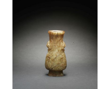 A PALE GREEN JADE ARCHAISTIC VASE, HUMing Dynasty The vase of flattened pear shape rising from a slightly spreading foot to a