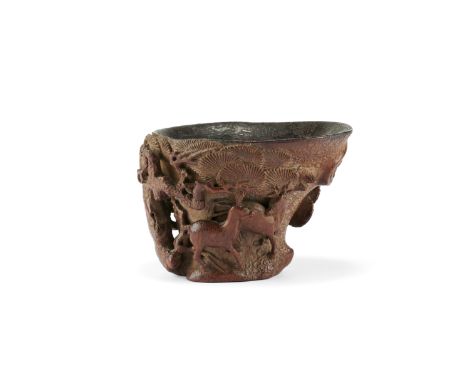 A bamboo 'deer and pine' libation cup17th/18th centuryWell carved after the form of a rhinoceros horn cup with a flared rim, 