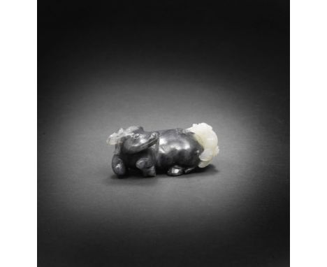 A BLACK AND WHITE JADE CARVING OF AN OX AND MYTHICAL BEAST18th/19th century Crisply carved, the ox lying placidly on its stom