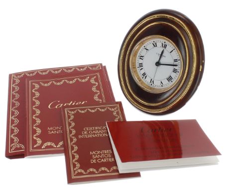 Cartier Ellipse easel travelling clock, the 2" white dial signed Cartier, Paris, Swiss Made, within an oval faux tortoiseshel