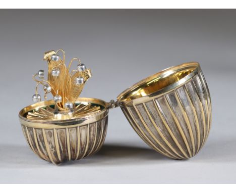 Egg in silver and enamel, the interior contains a sprig of lily of the valley circa 1900Sizes: H=85mm D=50mmWeight (K): 0.187