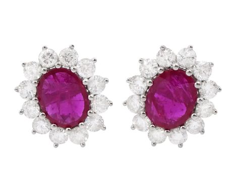 Pair of 18ct white gold oval ruby and round brilliant cut diamond cluster stud earrings, stamped 18K, total ruby weight appro