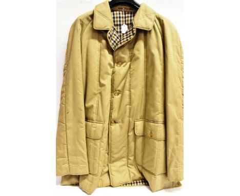 A GENTLEMAN'S 'BURBERRY' WAXED COTTON WEATHERPROOF NAVY COAT with check lining, size XX'; a Gentleman's 'Aquascutum' beige co