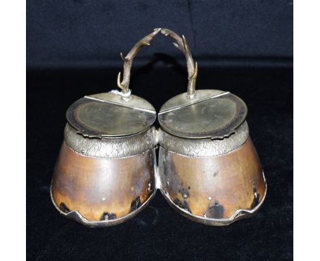 A DOUBLE HORSE HOOF INKWELL  with plated shoes and mounts and twin antler grips, height 14cm, width 23cm