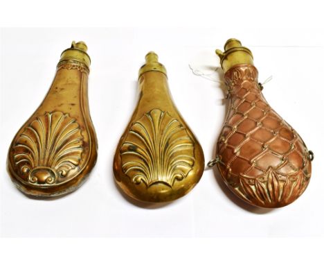 A COPPER POWDER FLASK with woven rope decoration in relief and with brass mount and two further brass powder flasks, copper f