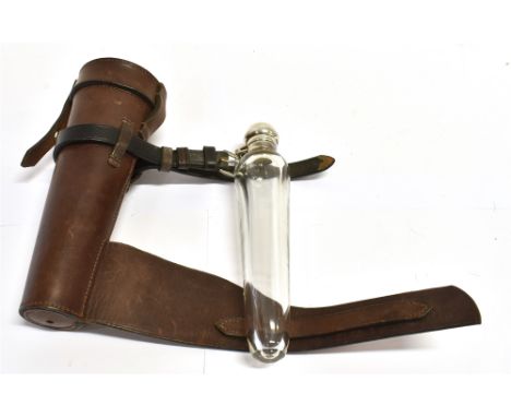 A TAPERED GLASS FLASK with plated flip top in leather holder for saddle mounting, 23cm