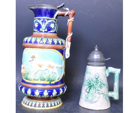 A 19th century Victorian era George Jones Majolica Fox and Dog hunting themed jug. The jug having modelled fox and dog vignet