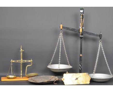 A collection of vintage 20th century scales comprising of two weighing scales having two brass trays held by chains together 