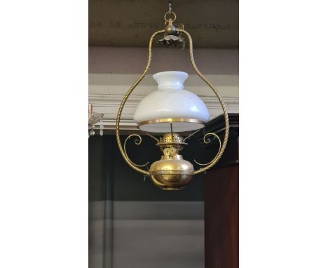 Late Victorian hanging oil lamp with roped and scroll bracket with white opaque mushroom shade.
