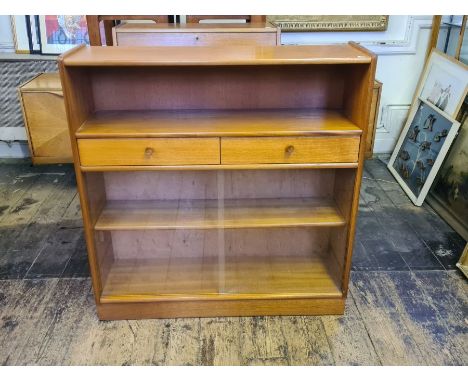 A mid century Nathan teak bookcase with 2 drawers, glass sliders and open shelf.  102cm wide x 30cm deep x 107cm tall.