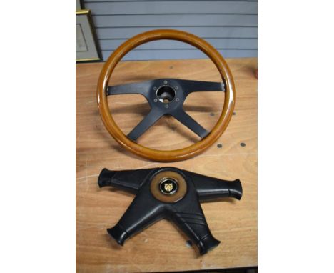 A vintage Momo steering wheel, with horn press.