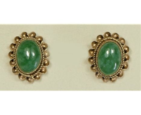 A 9ct gold pair of oval cabochon jade ear studs, 7 x 5mm, 1.6gm