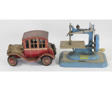 A tinplate car, friction rear wheel producing a mock engine noise, together with a Vulcan sewing machine (2) 