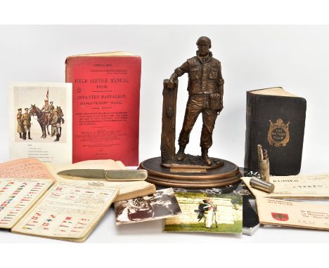 A BOX CONTAINING VARIOUS MILITARY ITEMS, to include a copy of the Soldiers Bible, which is numbered 286040 and a paperback Mi