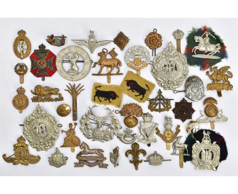 A BOX CONTAINING OVER THIRTY MILITARY CAP BADGES AND INSIGNIA, to include Argyll &amp; Sutherland, KOSB, The Buffs, Lancashir