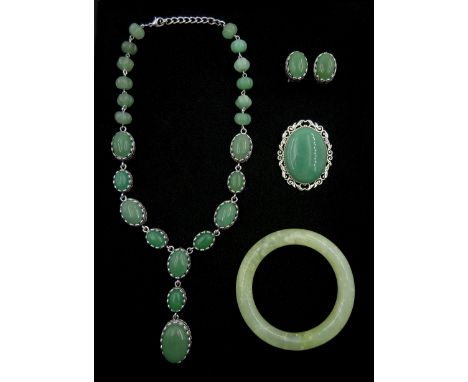 Collection of jade jewellery including bead necklace, pair of stud earrings, brooch and bangle