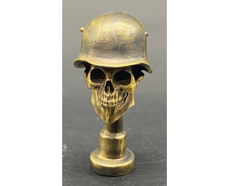 Bronze pipe tamper in the form of a skull 