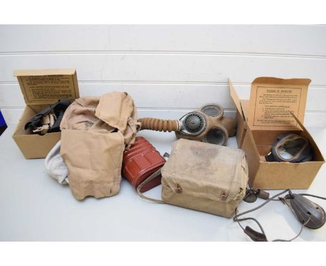 FOUR VINTAGE WORLD WAR BOXED RESPIRATOR GAS MASKS TOGETHER WITH A FURTHER LARGER EXAMPLE
