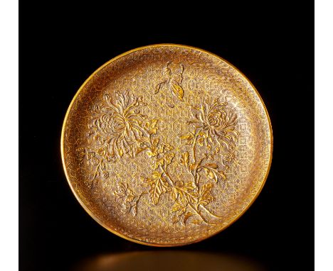 A guilded lacquered dish China, Qing dynasty, 19th century  Carved with flowers over geometric background and bearing a Kangx