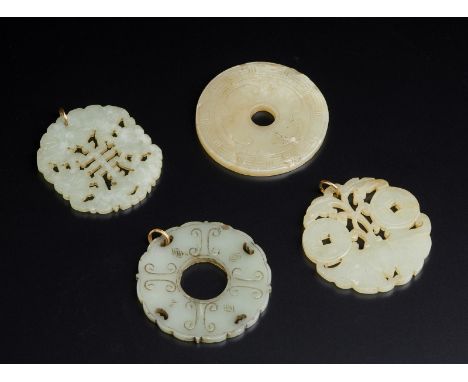 A group of four round jade pendants with openwork decoration China, Qing dynasty, 20th century   Cm 6,00