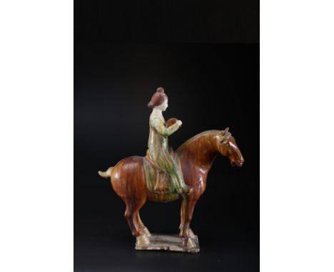 A ceramic sancai glazed lady on horse in the Tang styleChina, 19th century   Cm 41,00 x 47,00