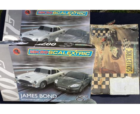 Scalextric: A collection of three boxed Scalextric sets, two James Bond 007 Micro Scalextric sets each containing Aston Marti