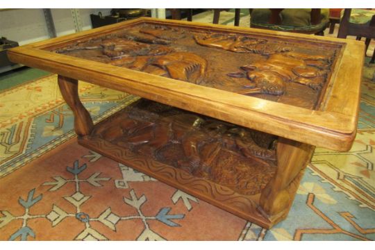 A glass topped African wood coffee table from Zimbabwe, the top with ...