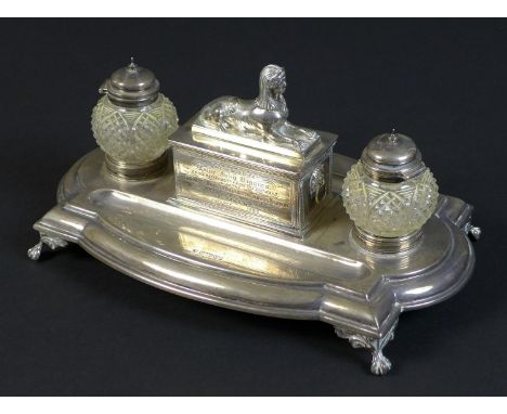 A Victorian silver military presentation inkwell stand, bearing an inscription to its central sphinx lidded sarcophagus style