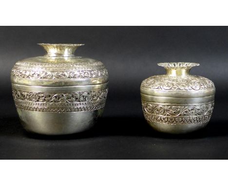 Two Cambodian Khmer silver pomegranate shaped boxes, likely late 19th or early 20th century, both chased and repousse decorat