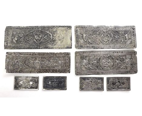 A group of Chinese or South East Asian white metal book binding covers, each of rectangular form with pierced holes to the ri