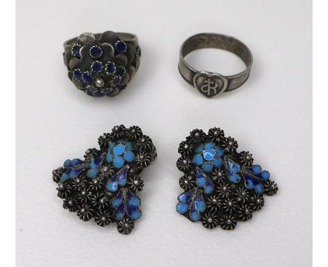 A pair of white metal ear-clips, likely Russian silver, with turquoise cloisonne detail amongst floral motifs, each 2.4 by 2.